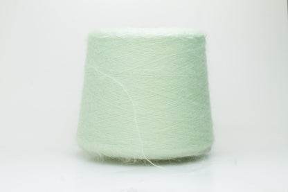 Close-up view of Light Green SuperKidMohair yarn showing a dense, fluffy pile structure and subtle sheen. The yarn has a uniform ply twist with a rich color depth.