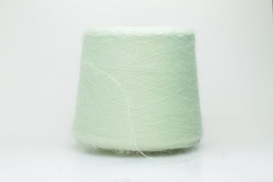Close-up view of Light Green SuperKidMohair yarn showing a dense, fluffy pile structure and subtle sheen. The yarn has a uniform ply twist with a rich color depth.