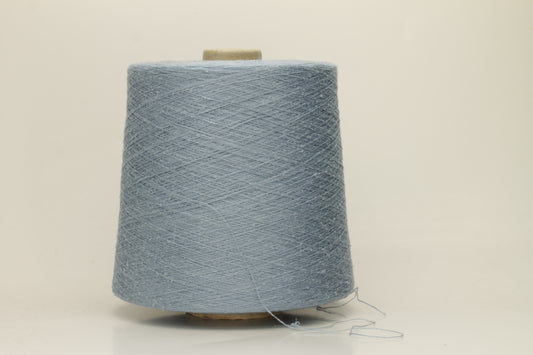 A tightly twisted single strand of luxurious deep royal blue silk yarn, reflecting light with a soft, natural sheen.