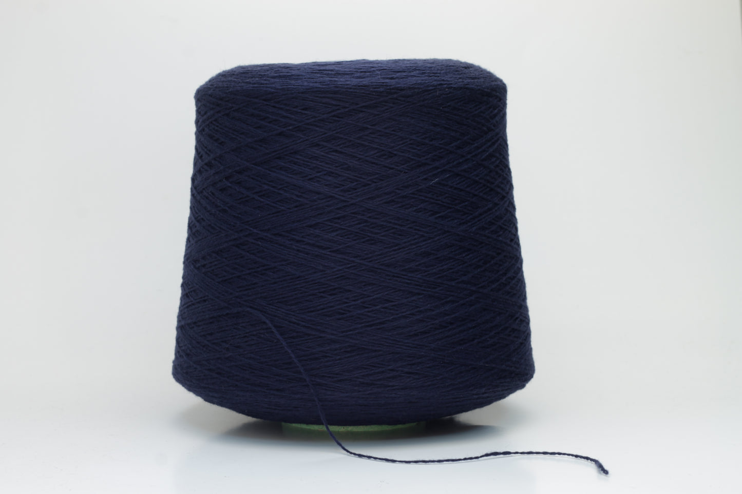 Luxurious Navy cashmere yarn, two-ply twist with a subtle sheen, displaying deep, consistent color and a fine, soft texture ready for crafting.
