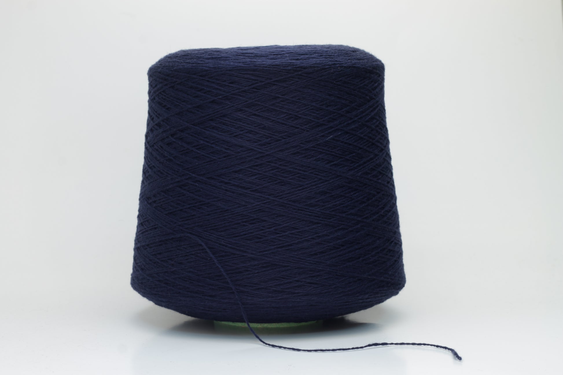 Luxurious Navy cashmere yarn, two-ply twist with a subtle sheen, displaying deep, consistent color and a fine, soft texture ready for crafting.