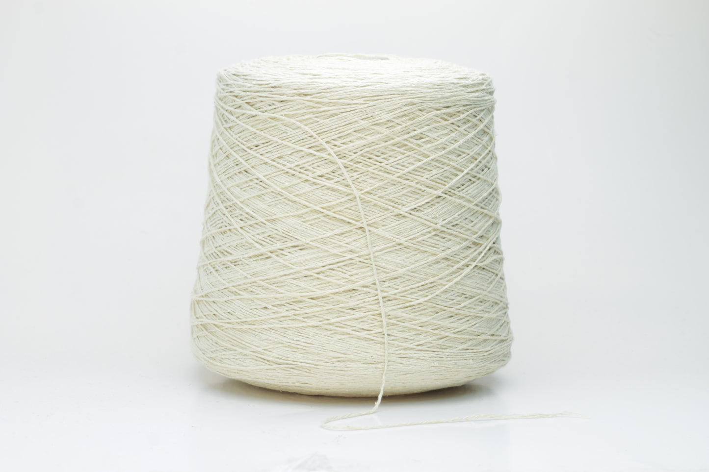 Close-up of creamy 'Giallino' Silk Bourette yarn, showcasing its incredibly fine ply twist and subtle sheen. The yarn has a smooth, almost liquid texture with abundant fluffiness.
