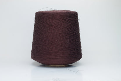 Close-up of a tightly twisted, fine-gauge yarn in a deep, warm earthy brown color, showing a subtle natural sheen from the linen fibers.