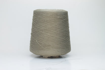 A skein of natural, undyed linen-polyamide yarn in an earthy beige. Features fine, even strands with a subtle organic texture and gentle luster.