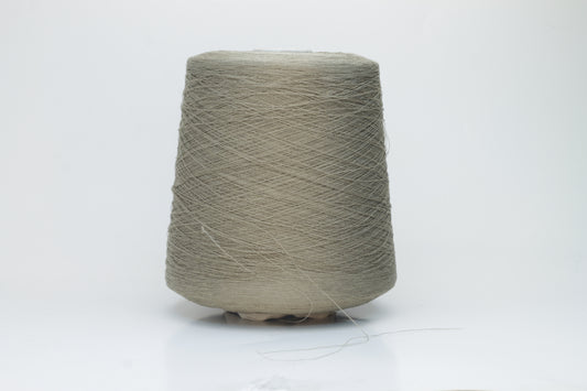 A skein of natural, undyed linen-polyamide yarn in an earthy beige. Features fine, even strands with a subtle organic texture and gentle luster.