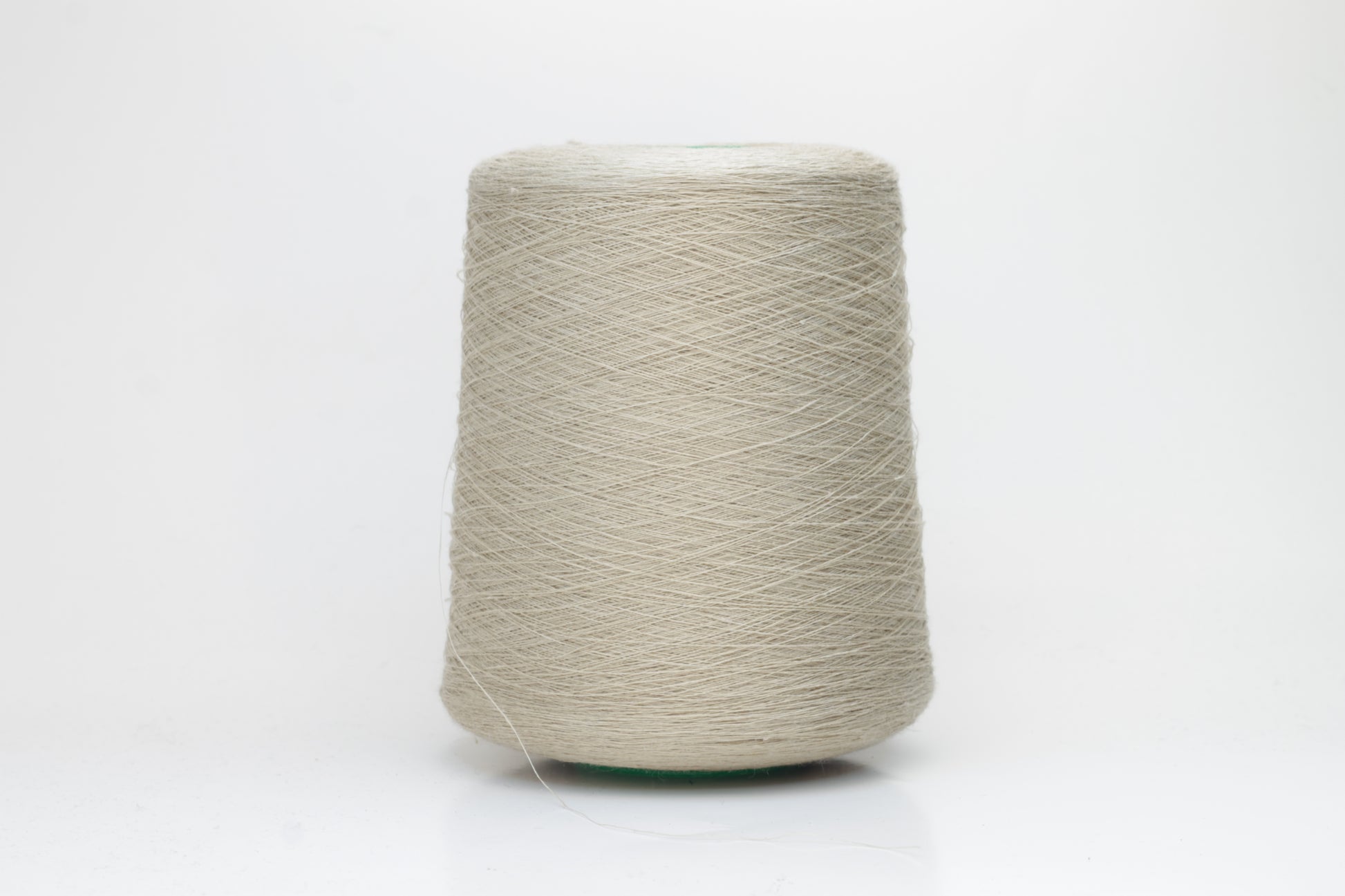 Fine, single-ply linen yarn in a rich Oatmeal. Reveals a crisp texture and subtle natural sheen, typical of pure linen fiber.