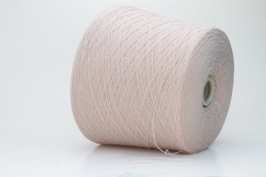Soft, slightly fuzzy two-ply cashmere yarn in a muted, warm dusty rose color with a subtle sheen, loosely wound in a skein.