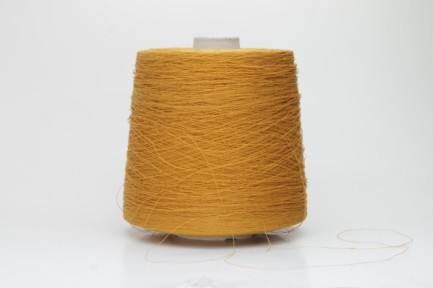 Close-up of a finely spun, vibrant orange yarn with a subtle, natural sheen. Its multi-filament structure shows a delicate twist, offering both crispness and soft resilience, suitable for textile artistry.