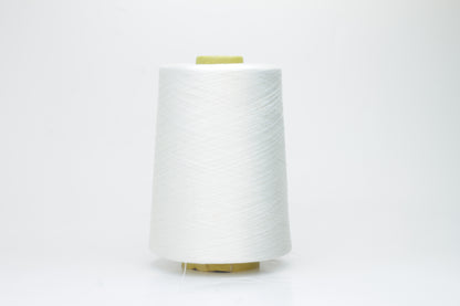 A close-up of premium 100% silk yarn, tightly plied, displaying a smooth, lustrous surface and a warm, creamy latte beige color.