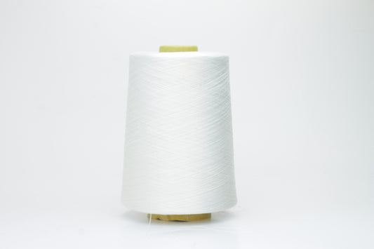 A close-up of premium 100% silk yarn, tightly plied, displaying a smooth, lustrous surface and a warm, creamy latte beige color.