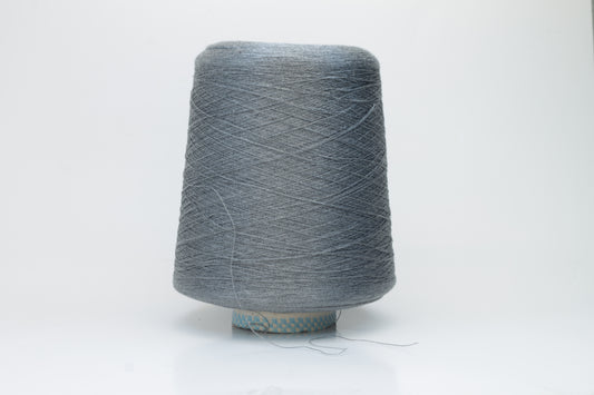 Close-up of a meticulously twisted two-ply 100% silk yarn, revealing a subtle, sophisticated medium gray hue with a natural, elegant sheen.