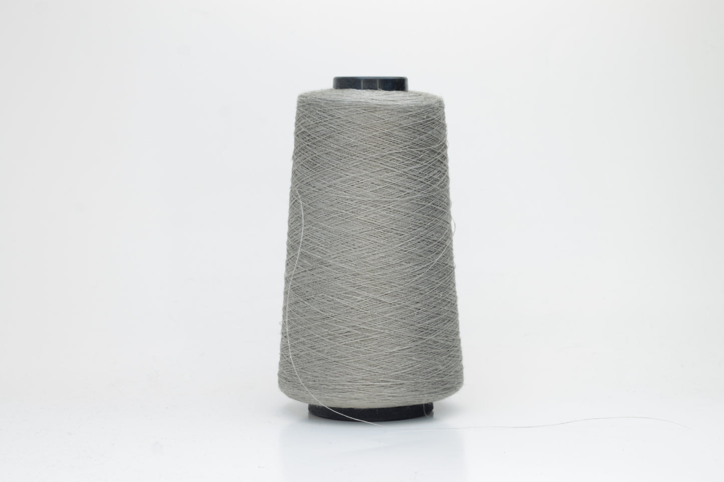 Fine, single-ply linen yarn in a rich Silver Gray. Reveals a crisp texture and subtle natural sheen, typical of pure linen fiber.