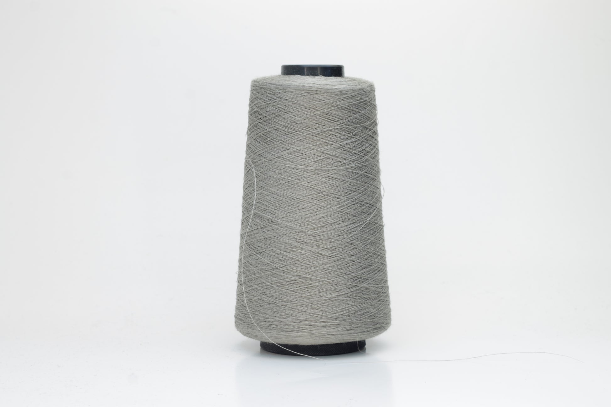 Fine, single-ply linen yarn in a rich Silver Gray. Reveals a crisp texture and subtle natural sheen, typical of pure linen fiber.