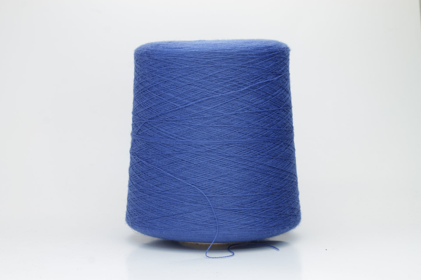 Close-up of luxurious petrol blue Merino wool yarn, two-ply twist with a soft, subtle sheen, and fine, consistent thread structure.