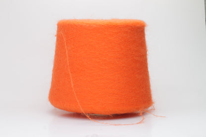 Close-up shot of vibrant orange SuperKidMohair yarn, displaying a tight ply twist and a rich, fluffy texture with noticeable sheen.