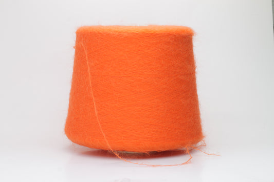 Close-up shot of vibrant orange SuperKidMohair yarn, displaying a tight ply twist and a rich, fluffy texture with noticeable sheen.