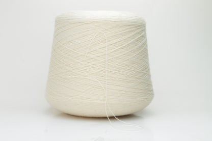 Close-up view of Zegna Baruffa Merino 100% Cashwool yarn in Milk Color. The yarn features a tight, even ply twist with visible thread structure, creating a subtle sheen and fluffy texture – perfect for intricate knitting designs.