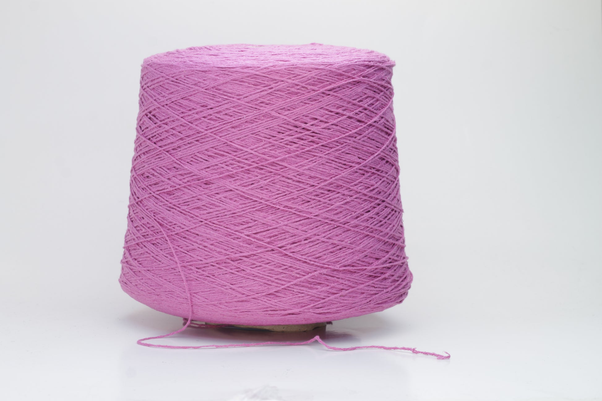 Close-up shot of the Rosa Fuxia Silk Bourette yarn, showcasing its shimmering, fluffy texture and tightly twisted ply structure. The silk fibers exhibit a subtle sheen with rich color depth.
