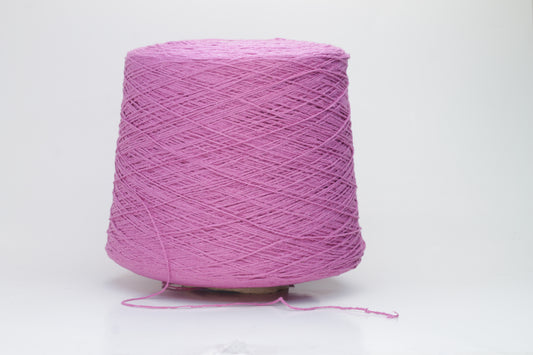 Close-up shot of the Rosa Fuxia Silk Bourette yarn, showcasing its shimmering, fluffy texture and tightly twisted ply structure. The silk fibers exhibit a subtle sheen with rich color depth.