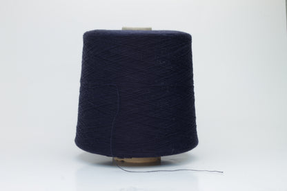 Close-up shot of dark blue, fluffy cotton 85% cashmere 15% yarn in a twisted ply, showcasing the fine thread structure and subtle sheen.