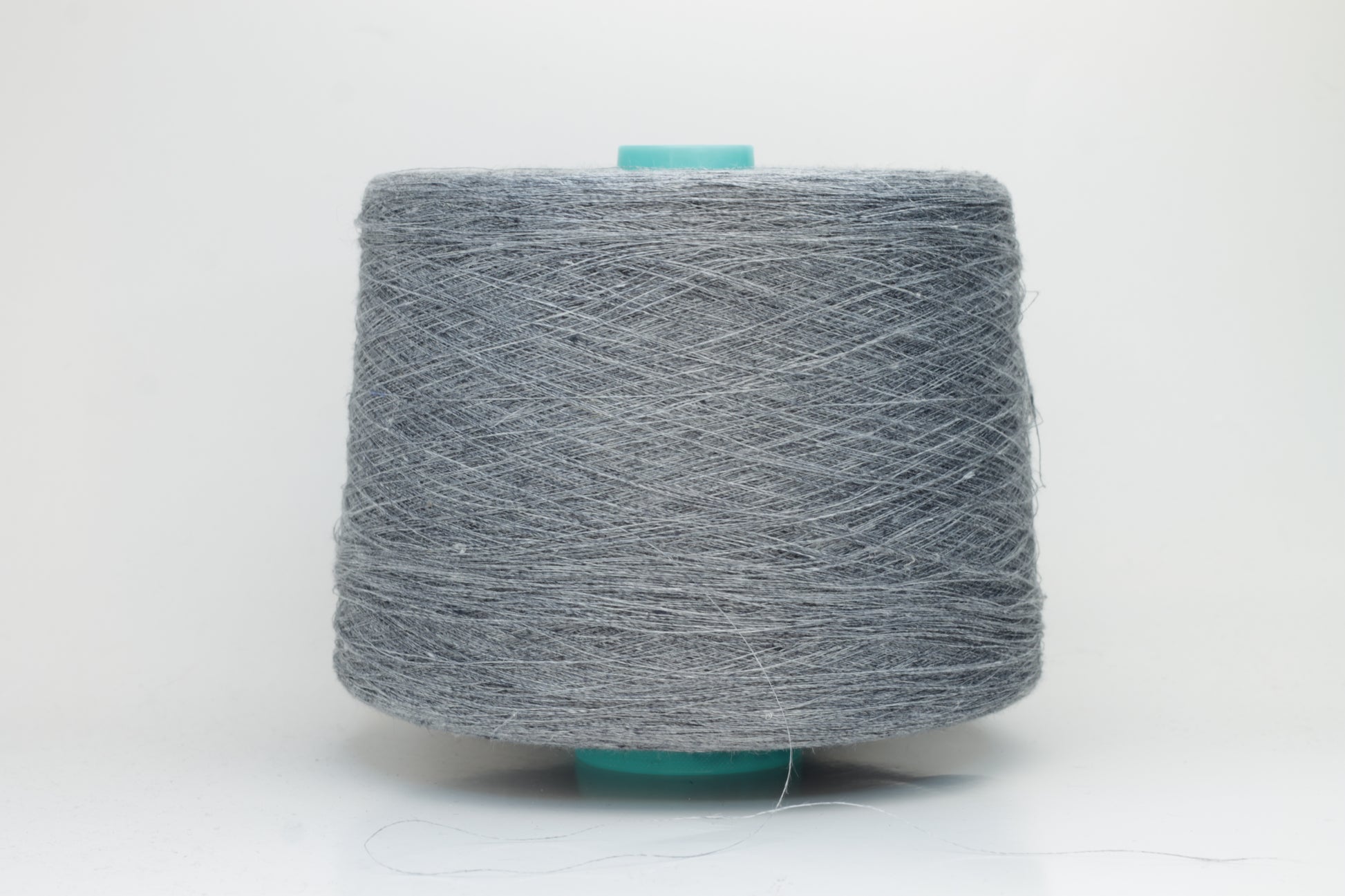 Fine, single-ply linen yarn in a rich Slate Blue-Gray. Reveals a crisp texture and subtle natural sheen, typical of pure linen fiber.