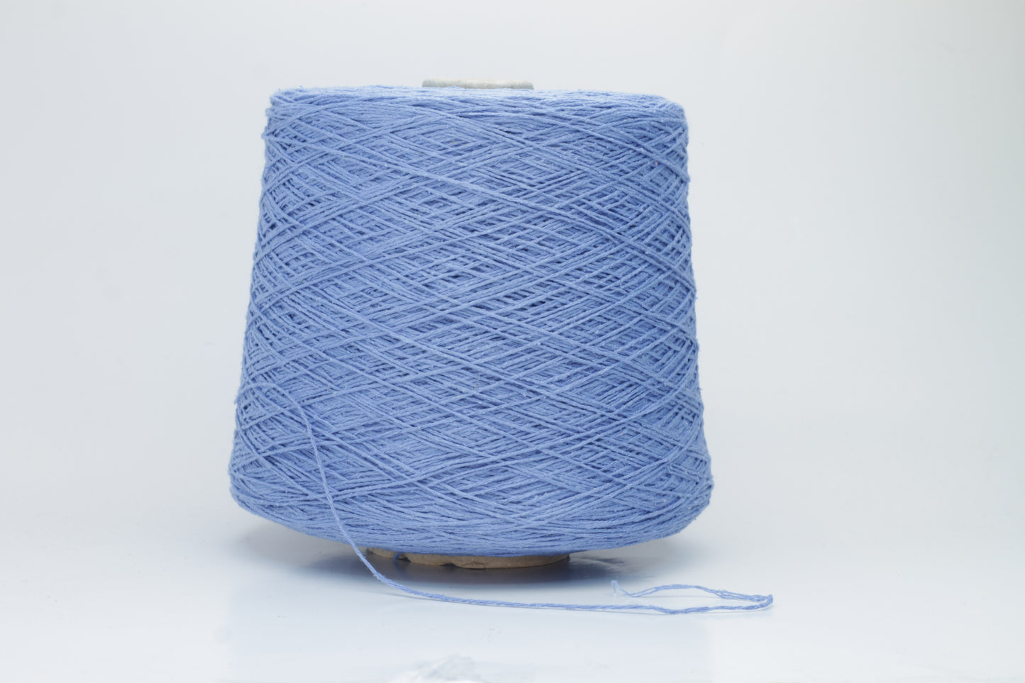 Close-up of a skein of deep Blue bourette silk yarn, showing its characteristic subtle slubs and matte texture, with a gentle, soft twist.