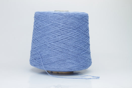 Close-up of a skein of deep Blue bourette silk yarn, showing its characteristic subtle slubs and matte texture, with a gentle, soft twist.