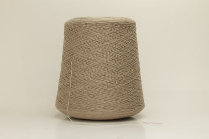 Close-up of a skein of incredibly soft, two-ply cashmere yarn in a deep, warm Mastice beige. Fine fibers with a subtle halo and elegant twist visible.