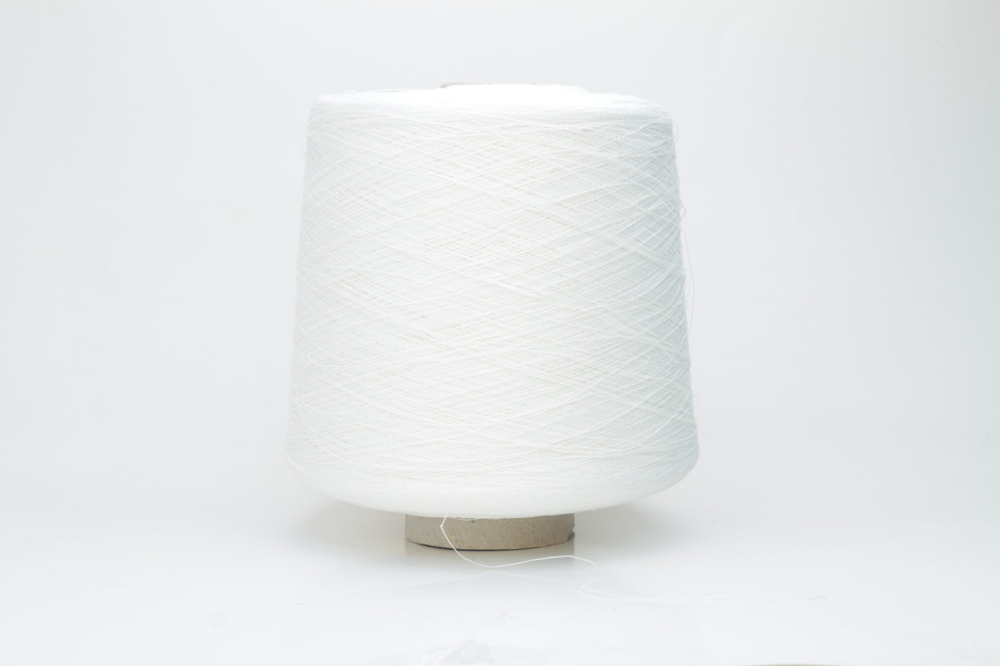 A bright white, single-ply yarn, subtly twisted, revealing the natural texture of linen fibers with a soft, understated sheen.