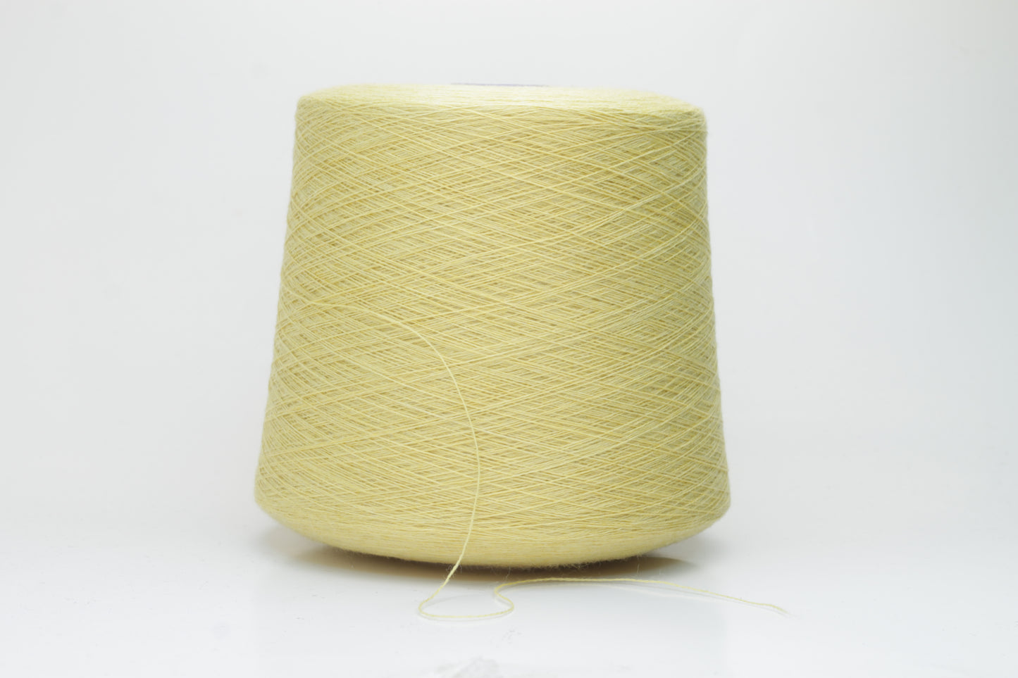 Close-up image of a vibrant yellow ZEGNA Baruffa merino yarn skein, showcasing its fine ply twist and dense thread structure with subtle sheen and inviting fluffiness.