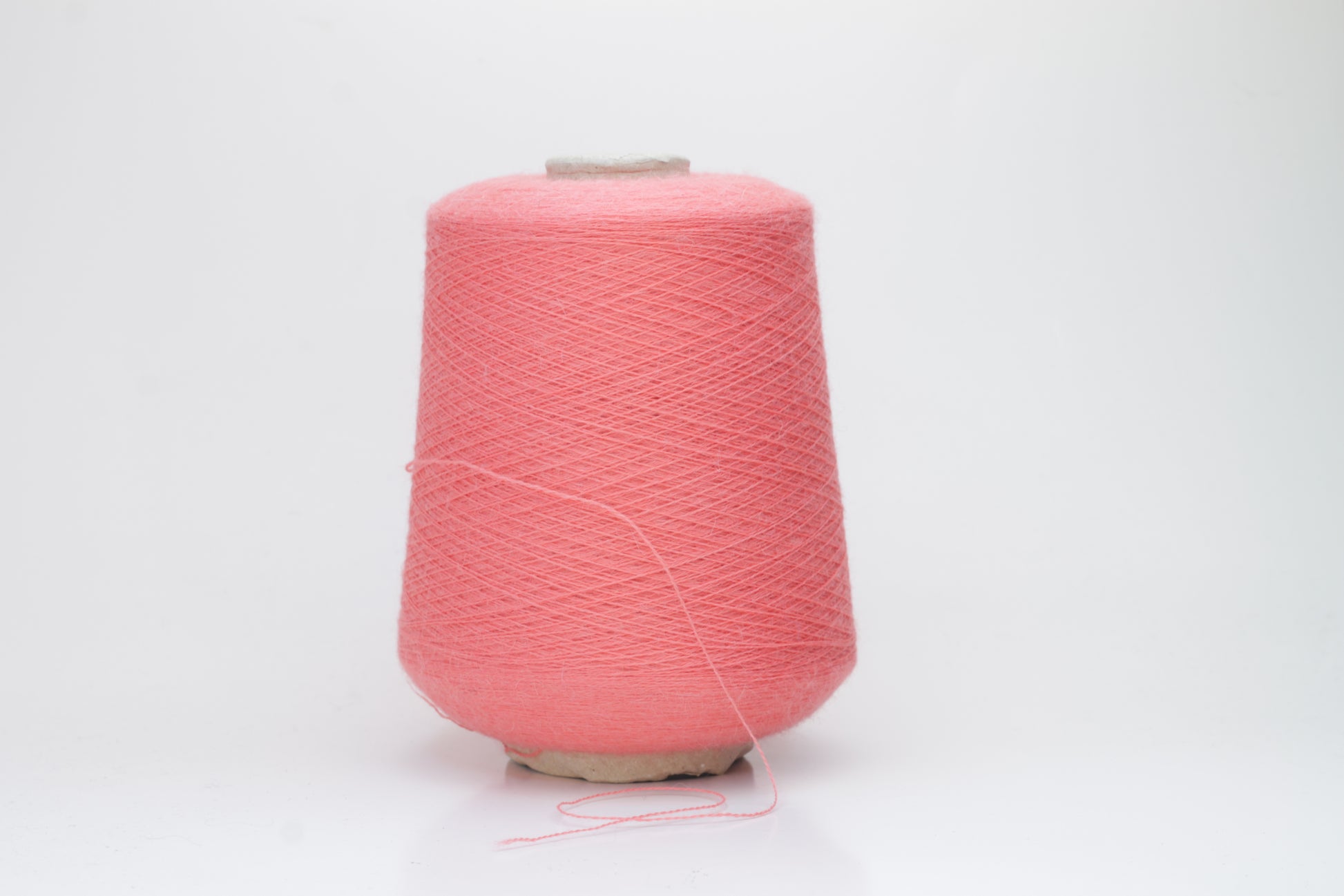 Coral 2-ply Alpaca Merino yarn, softly twisted with a gentle halo and subtle sheen, showcasing its deep, luxurious color saturation.