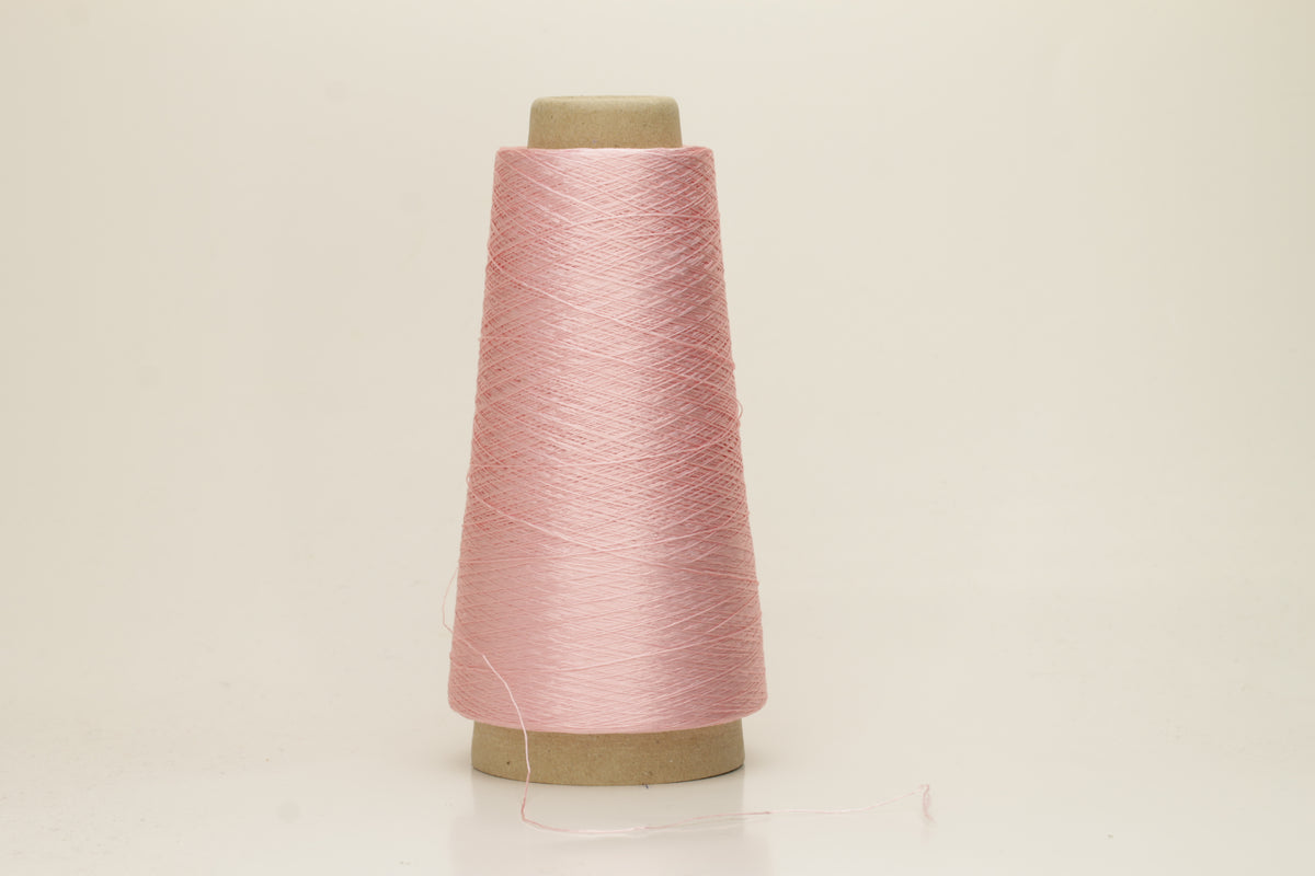 Close-up of pristine Rosa, finely plied 100% silk yarn, twisted smoothly to reveal a high, lustrous sheen and uniform structure.