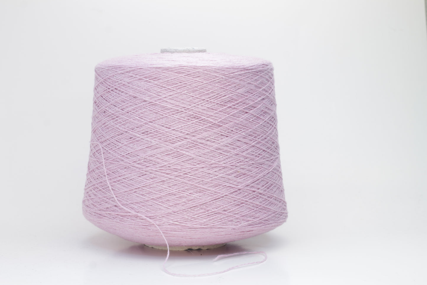 A soft, plump 2-ply yarn in a delicate antique rose hue, loosely coiled, exhibiting a subtle, silken sheen and slight halo. The fibers appear evenly spun.