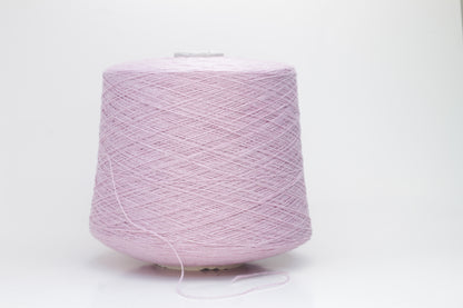 A soft, plump 2-ply yarn in a delicate antique rose hue, loosely coiled, exhibiting a subtle, silken sheen and slight halo. The fibers appear evenly spun.