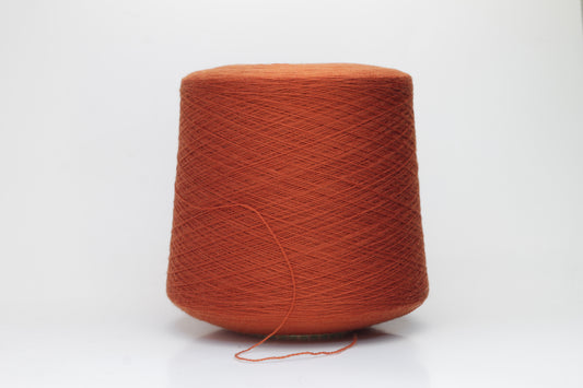 Close-up of luxurious Terra Cotta Merino wool yarn, two-ply twist with a soft, subtle sheen, and fine, consistent thread structure.