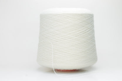 A close-up shot of a single ply, pure white alpaca yarn, softly twisted, showcasing its ethereal fluffiness and subtle sheen against a neutral background.