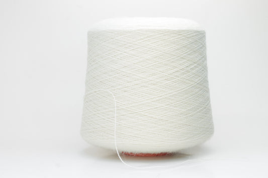 A close-up shot of a single ply, pure white alpaca yarn, softly twisted, showcasing its ethereal fluffiness and subtle sheen against a neutral background.