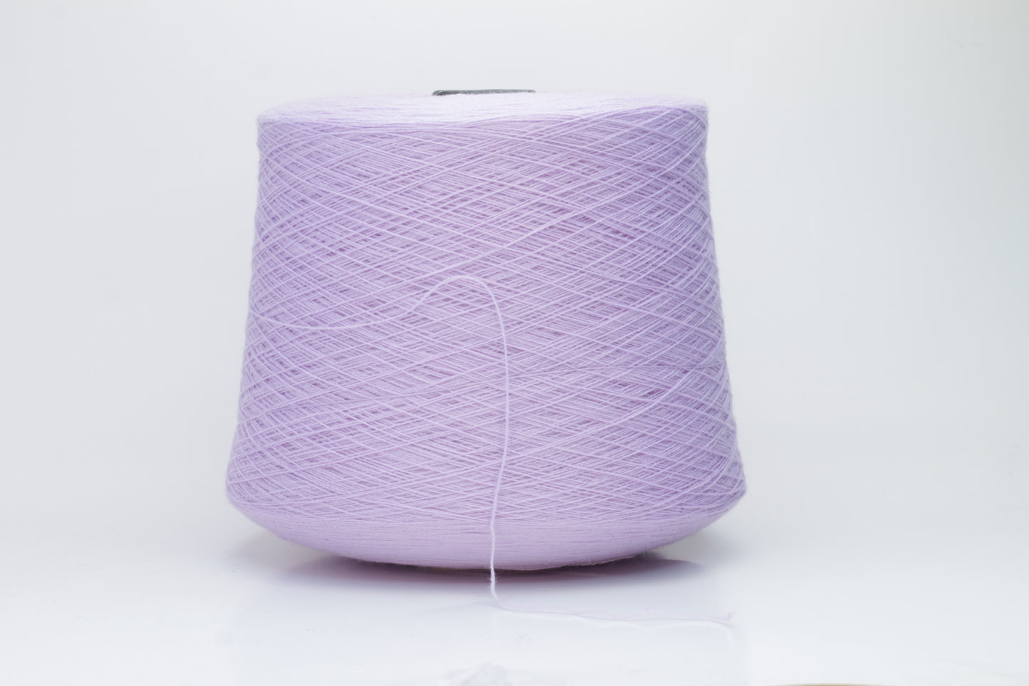 Close-up of soft, delicate two-ply cashmere yarn in a serene lavender hue, exhibiting a subtle halo and gentle sheen.