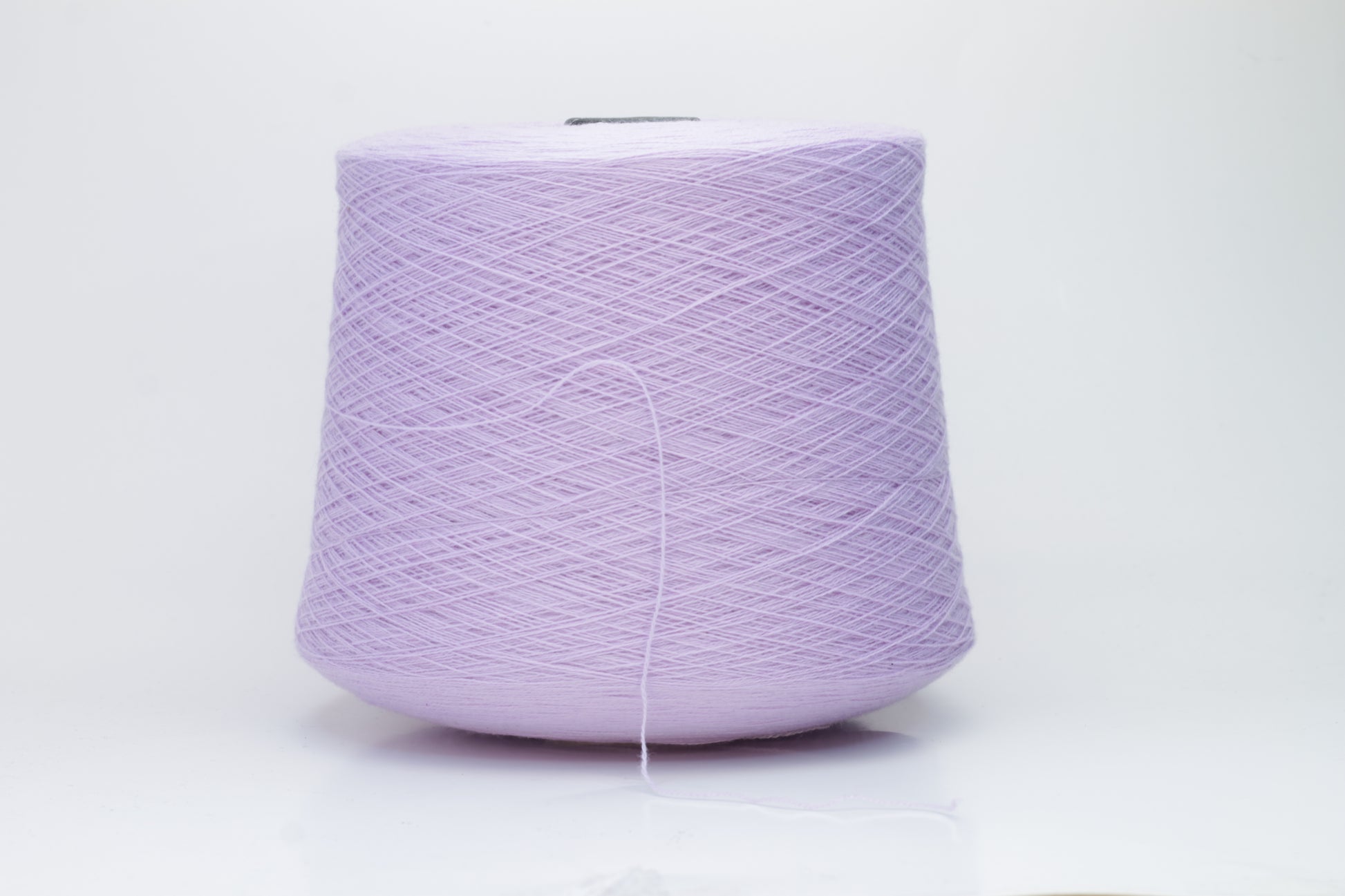 Close-up of soft, delicate two-ply cashmere yarn in a serene lavender hue, exhibiting a subtle halo and gentle sheen.
