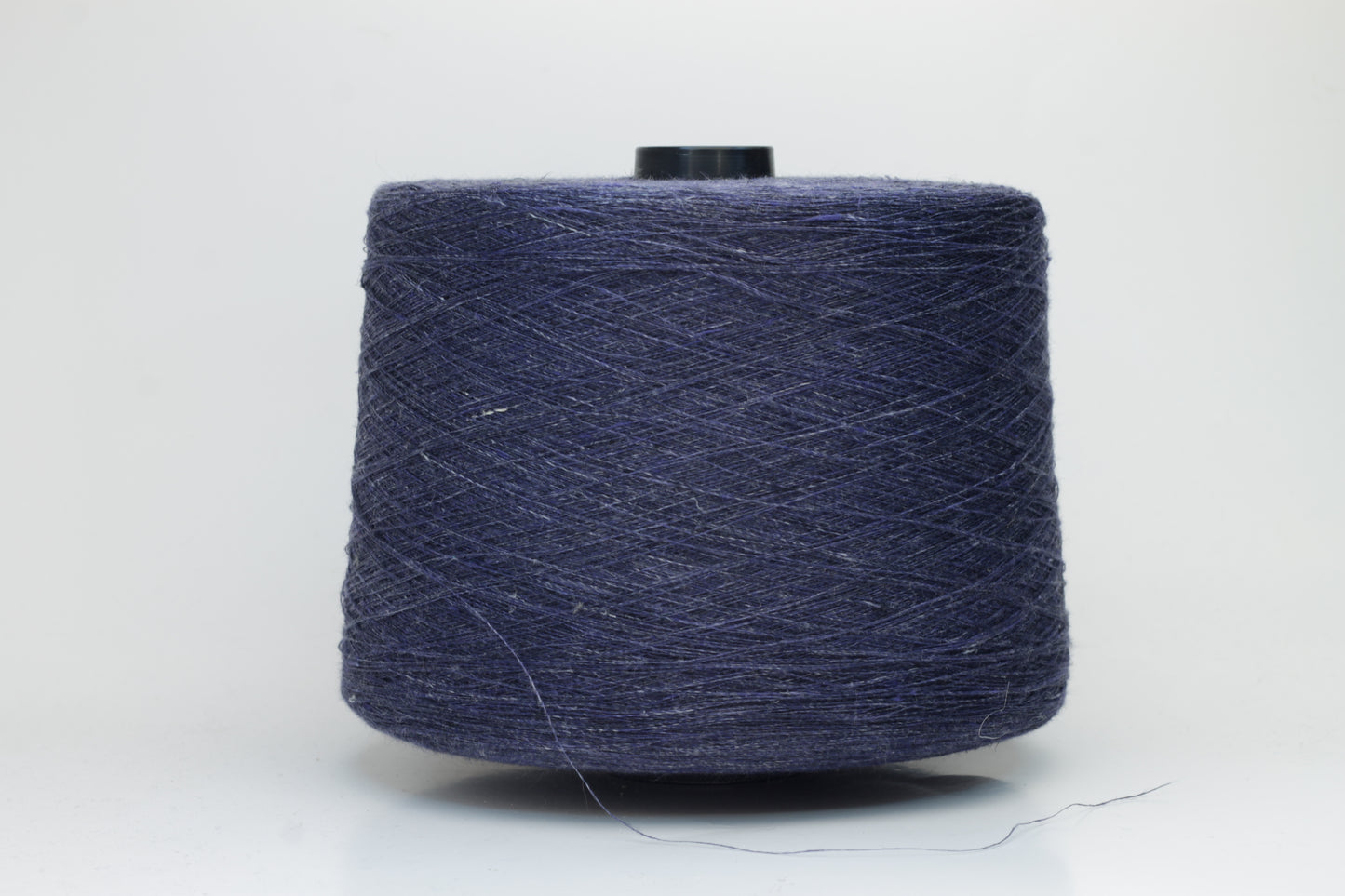 Fine, single-ply linen yarn in a rich Navy Blue. Reveals a crisp texture and subtle natural sheen, typical of pure linen fiber.