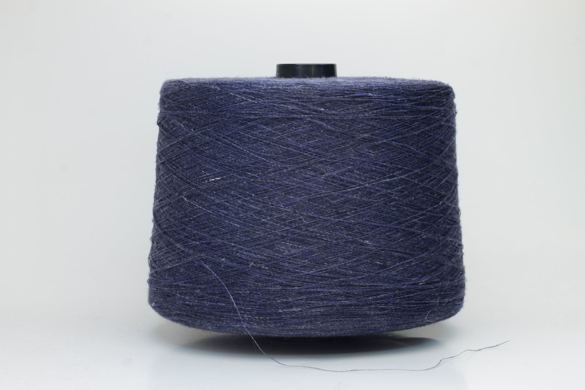 Fine, single-ply linen yarn in a rich Navy Blue. Reveals a crisp texture and subtle natural sheen, typical of pure linen fiber.