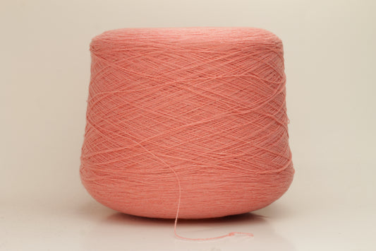 Close-up of soft, two-ply cashmere yarn in a delicate, even pink shade, showcasing its fine, slightly fuzzy texture and subtle sheen.