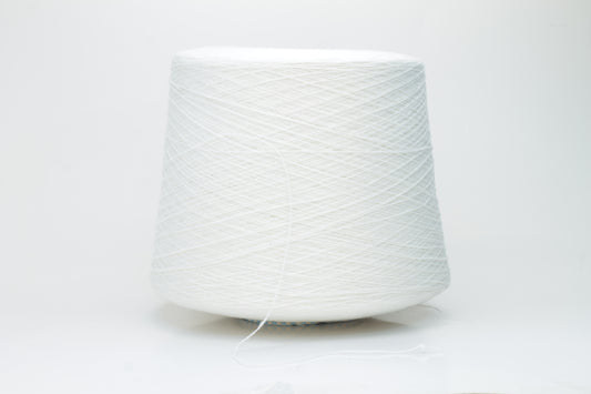 Close-up of a luxurious, soft skein of pale, milky blue cashmere yarn with a subtle sheen and light, even two-ply twist.