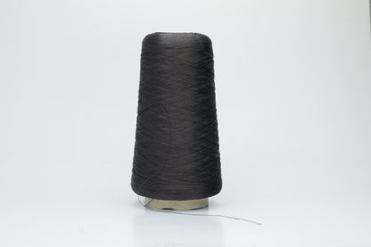 Coiled skein of single-ply, fine gauge silk yarn in a soft, bright sky blue. It exhibits a subtle, natural sheen with a smooth texture.