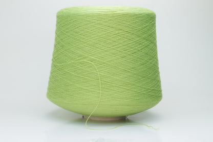 Close-up shot of the '100% Merino Toolegno 1900 Nm 2/30 Green Premium Yarn', showcasing the fluffy green fibers and a prominent ply twist, highlighting the dense thread structure and subtle sheen.
