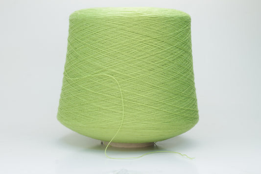 Close-up shot of the '100% Merino Toolegno 1900 Nm 2/30 Green Premium Yarn', showcasing the fluffy green fibers and a prominent ply twist, highlighting the dense thread structure and subtle sheen.