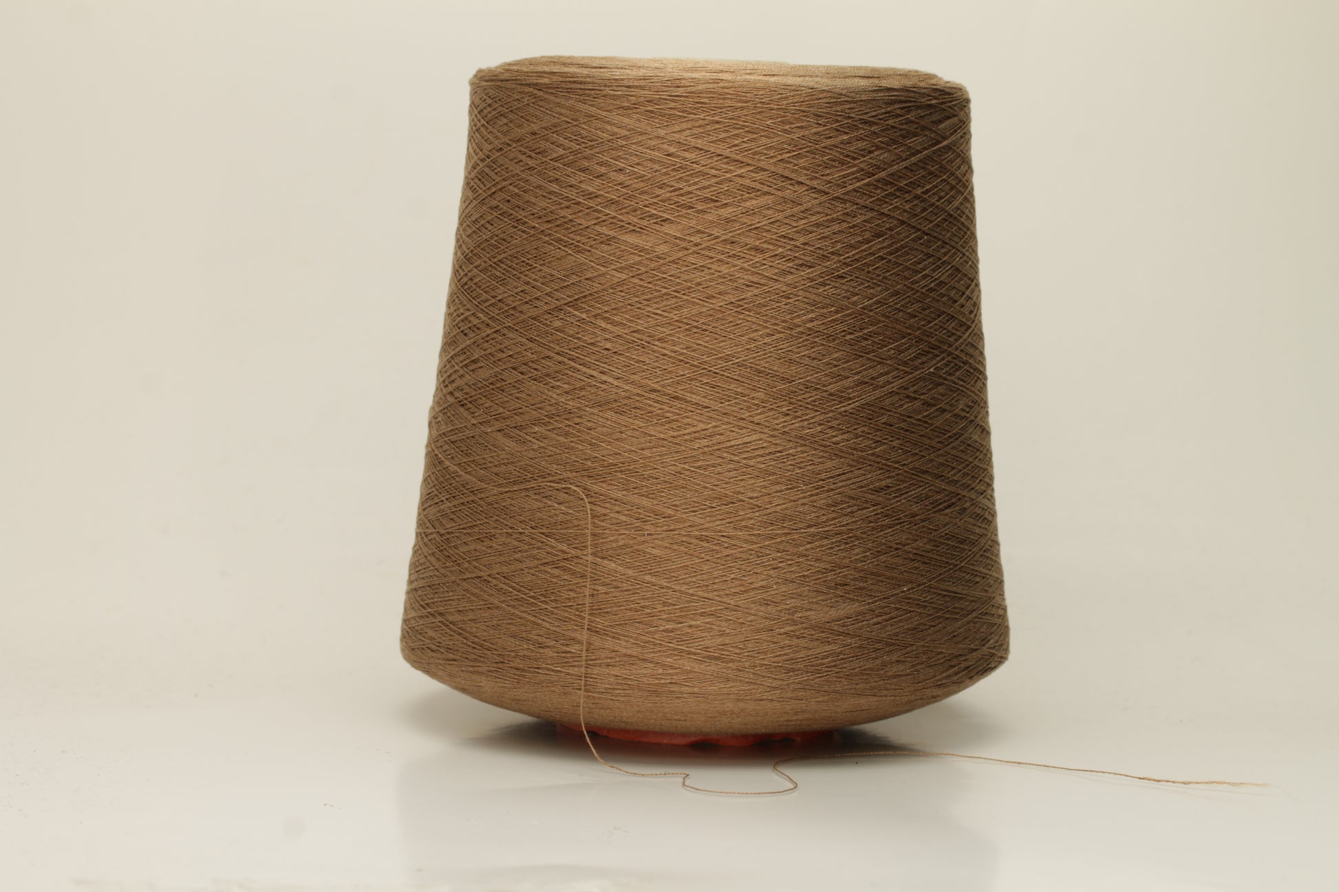 Close-up of a meticulously twisted 2-ply brown silk yarn, showcasing its deep, warm chocolate hue and brilliant, natural sheen, with a smooth, luxurious texture.