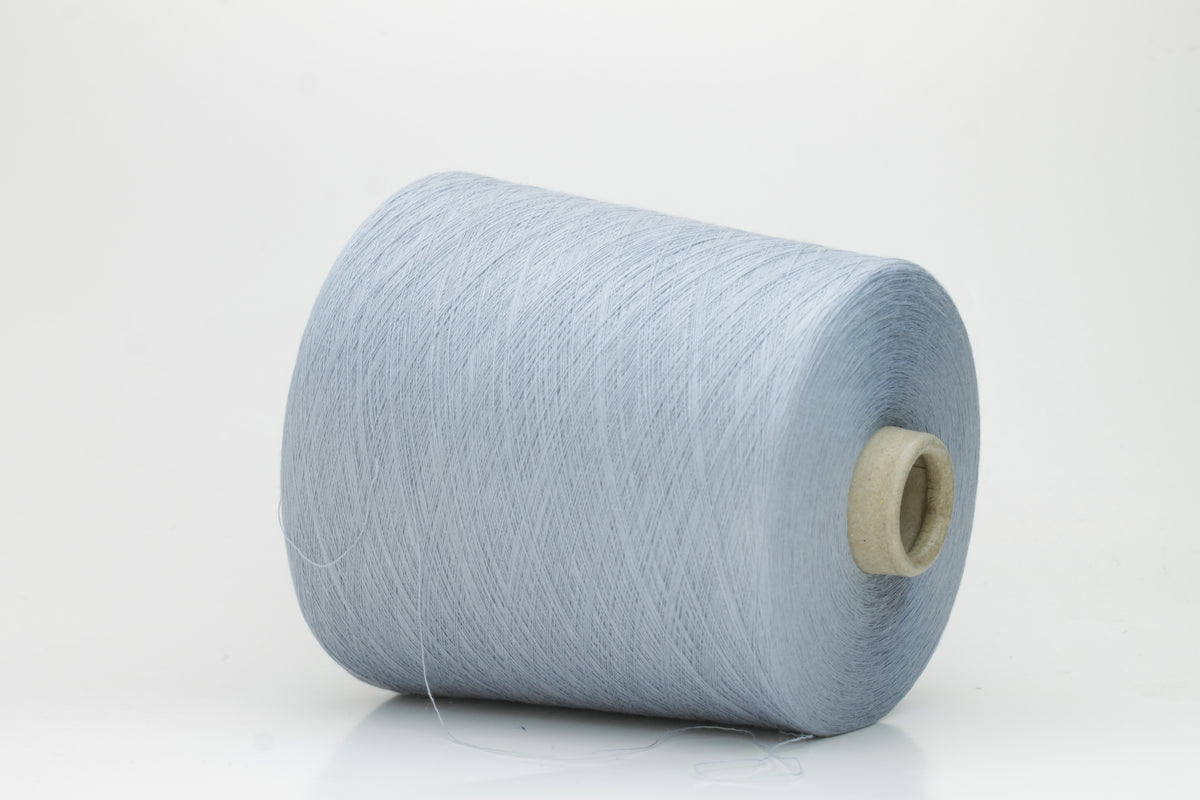 Close-up of pale frost blue 100% cotton yarn, exhibiting a tightly spun 4-ply structure with a soft, uniform sheen and smooth texture.