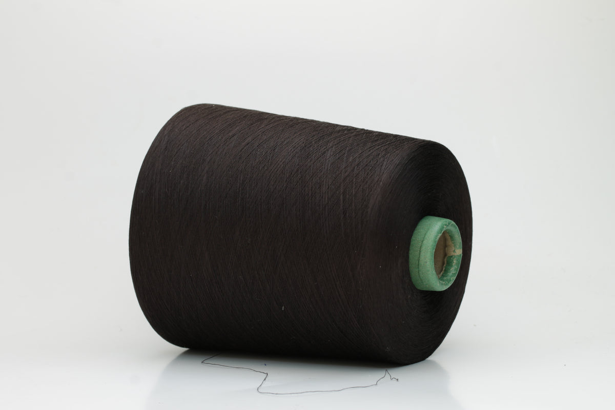 Close-up of smooth, dark Bitter Chocolate cotton yarn, tightly plied for a refined, lustrous finish. Shows even twist and deep, rich color.