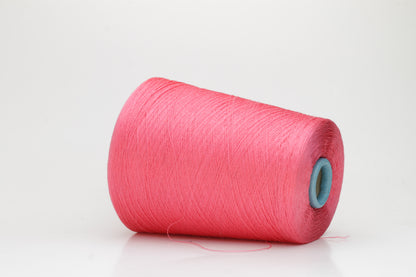 Close-up of a single ply, highly lustrous, smooth bright coral pink silk yarn with a subtle, delicate twist. The color is deep and vibrant.